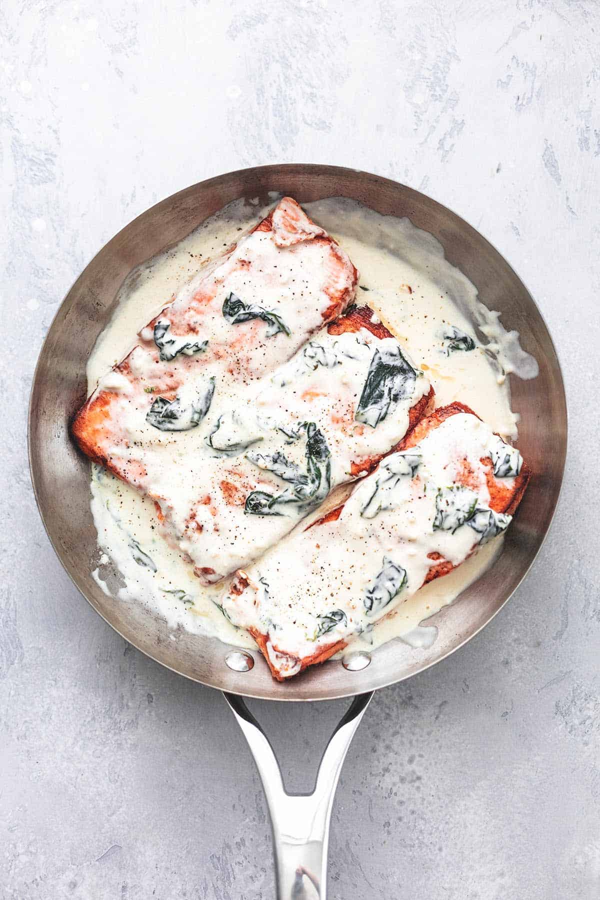 top view of salmon florentine in a skillet.