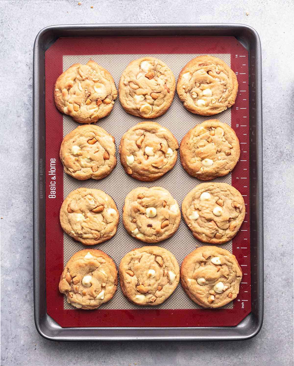 top view of chewy white chocolate cashew cookie on a baking sheet.