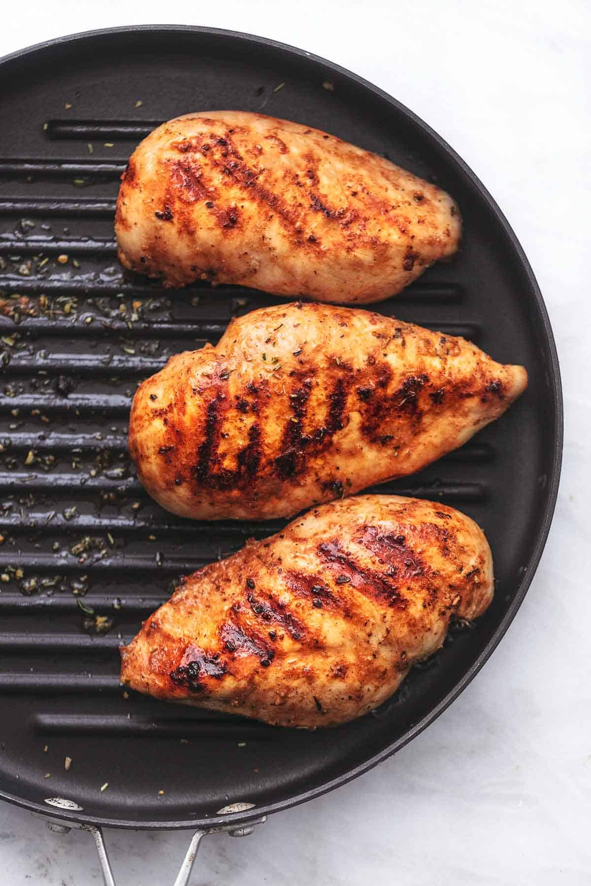 top view of chicken on a grill pan.