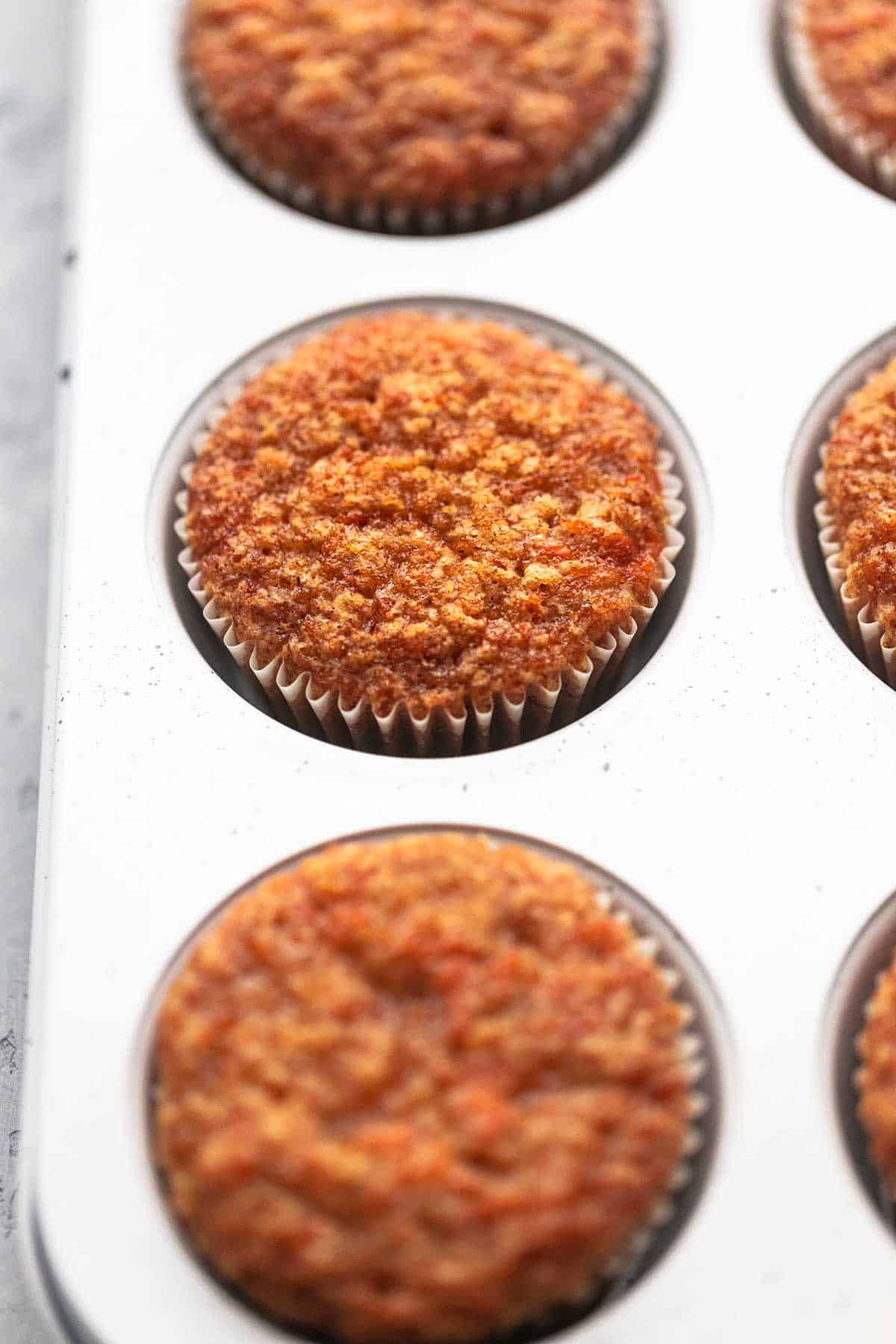 close up of carrot cake muffins in a muffin tin.