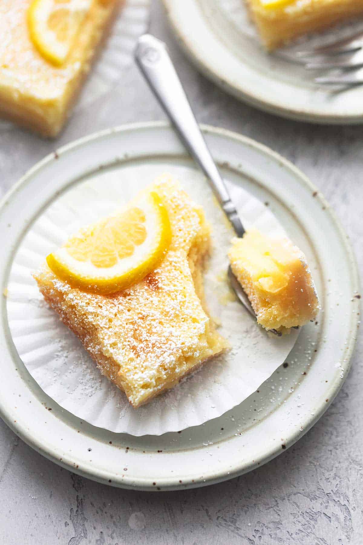 up close lemon bars with piece on fork