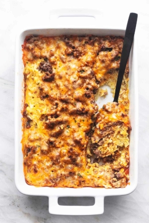 overhead breakfast casserole with a serving spoon in a baking dish