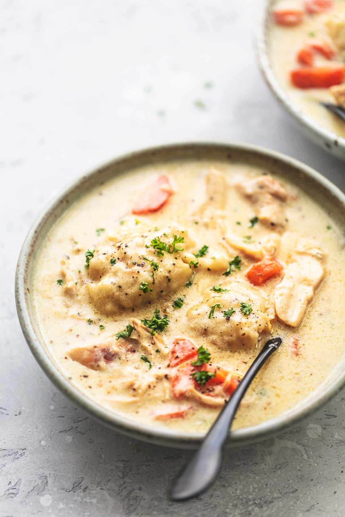 chicken and dumplings in bowl with spoon