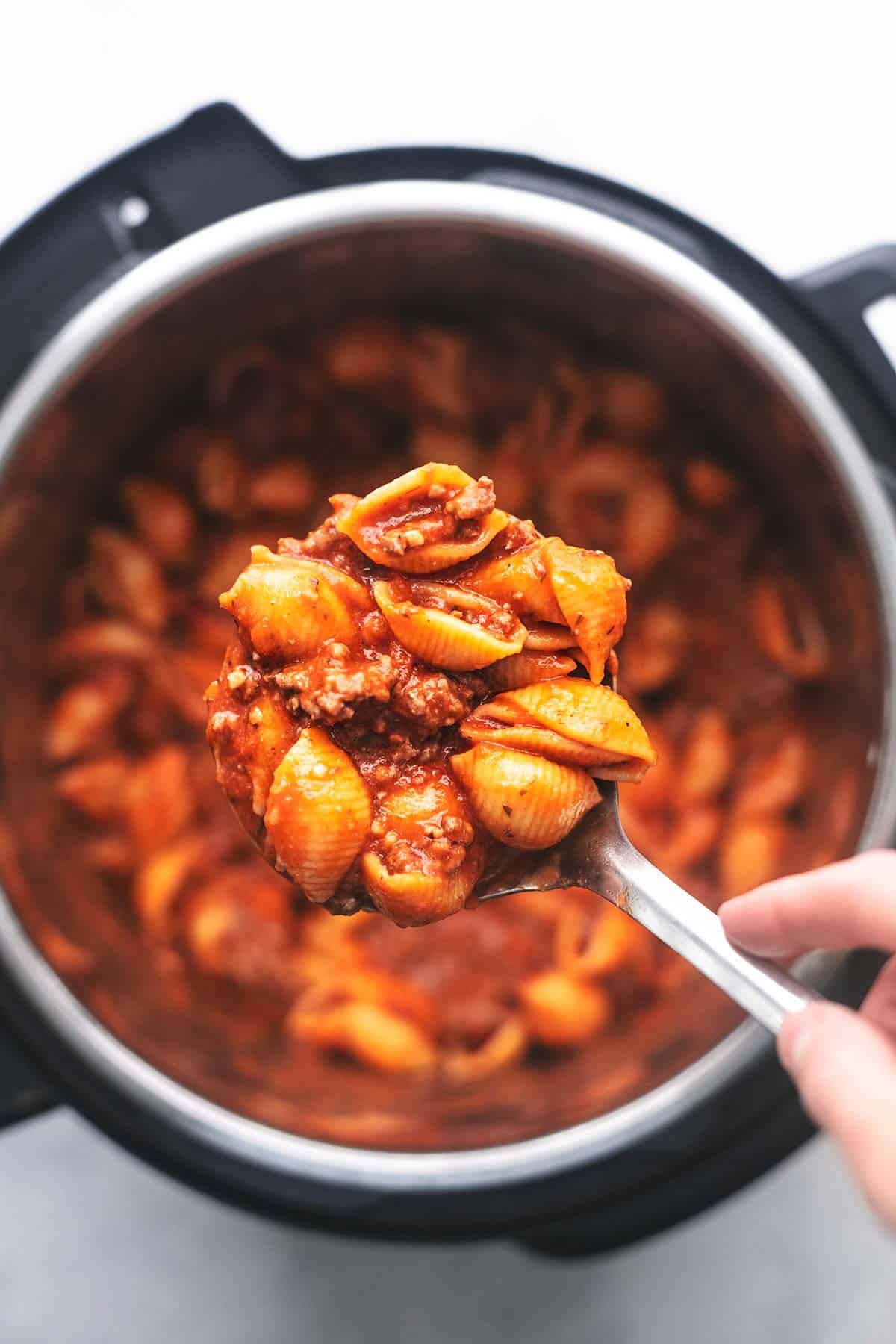 scoop of ground beef pasta over pressure cooker