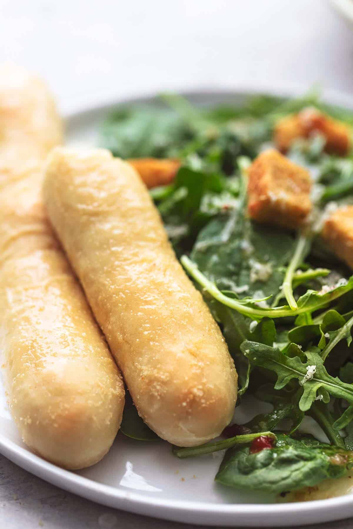 up close breadsticks on salad