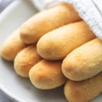 up close breadsticks with napkin on plate