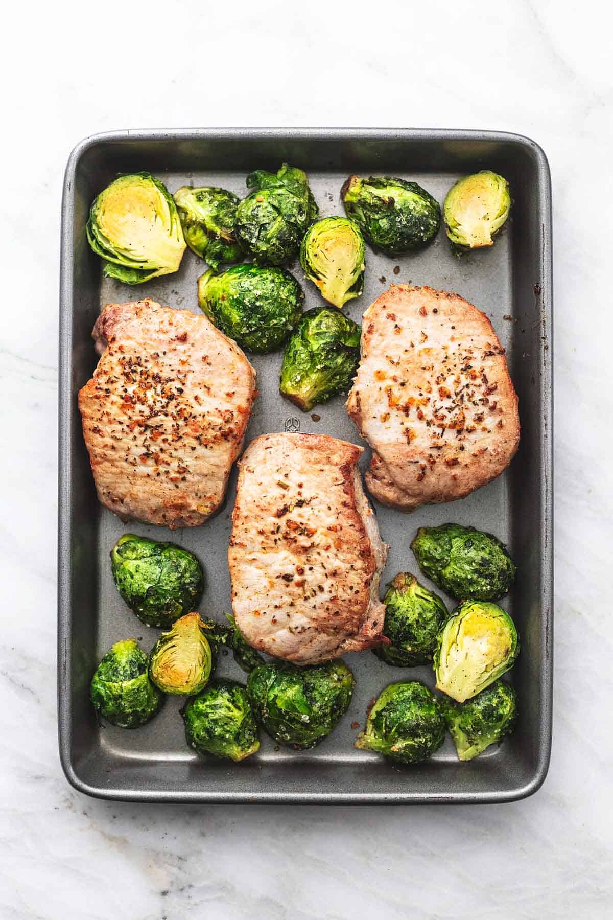 overhead pork chops and brussels sprouts on sheet pan