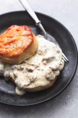 biscuits and sausage gravy with fork on plate