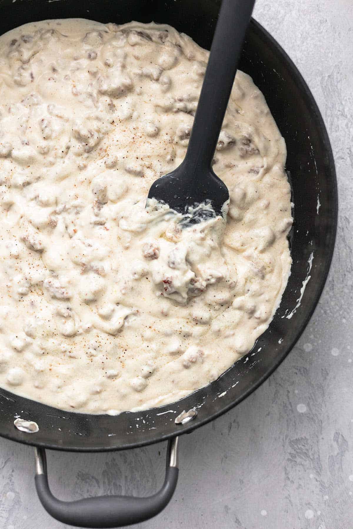 sausage gravy in skillet with spatula