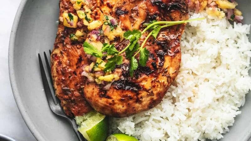 overhead chicken and pineapple salsa and white rice on gray plate