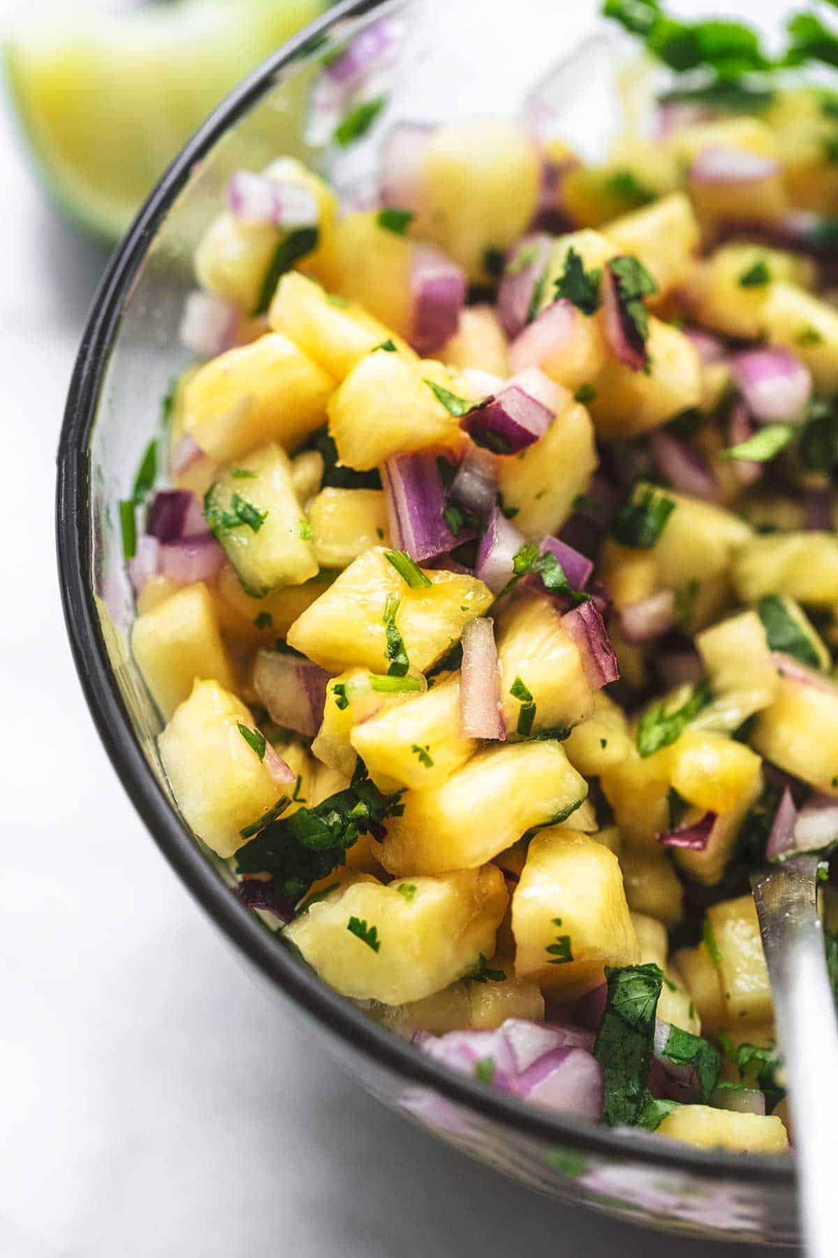 close up of pineapple salsa in a glass bowl.