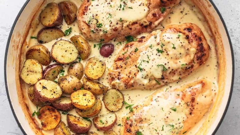 chicken and potatoes with cream sauce in skillet overhead