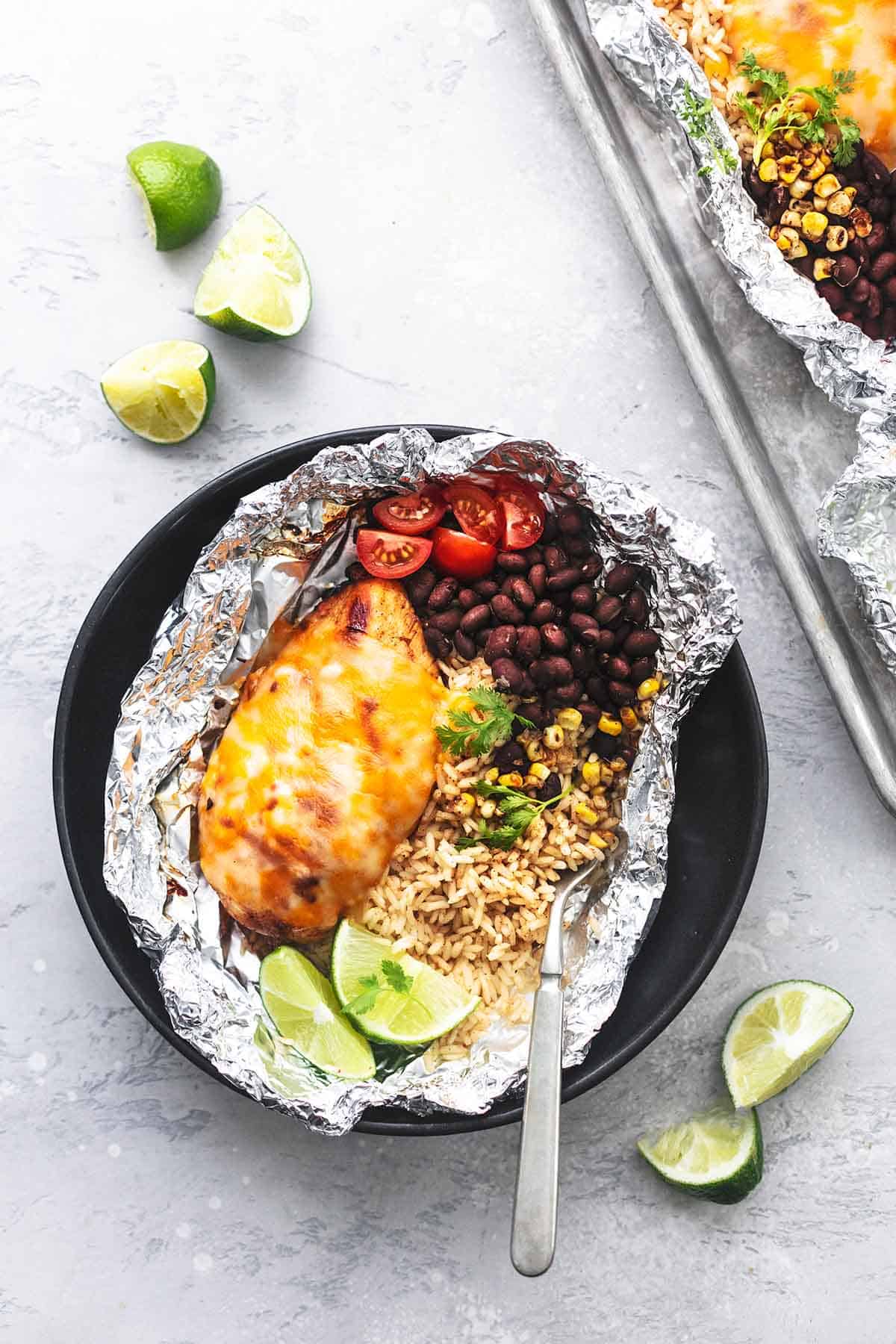 top view of a fiesta lime chicken and rice foil pack with a fork on a plate.