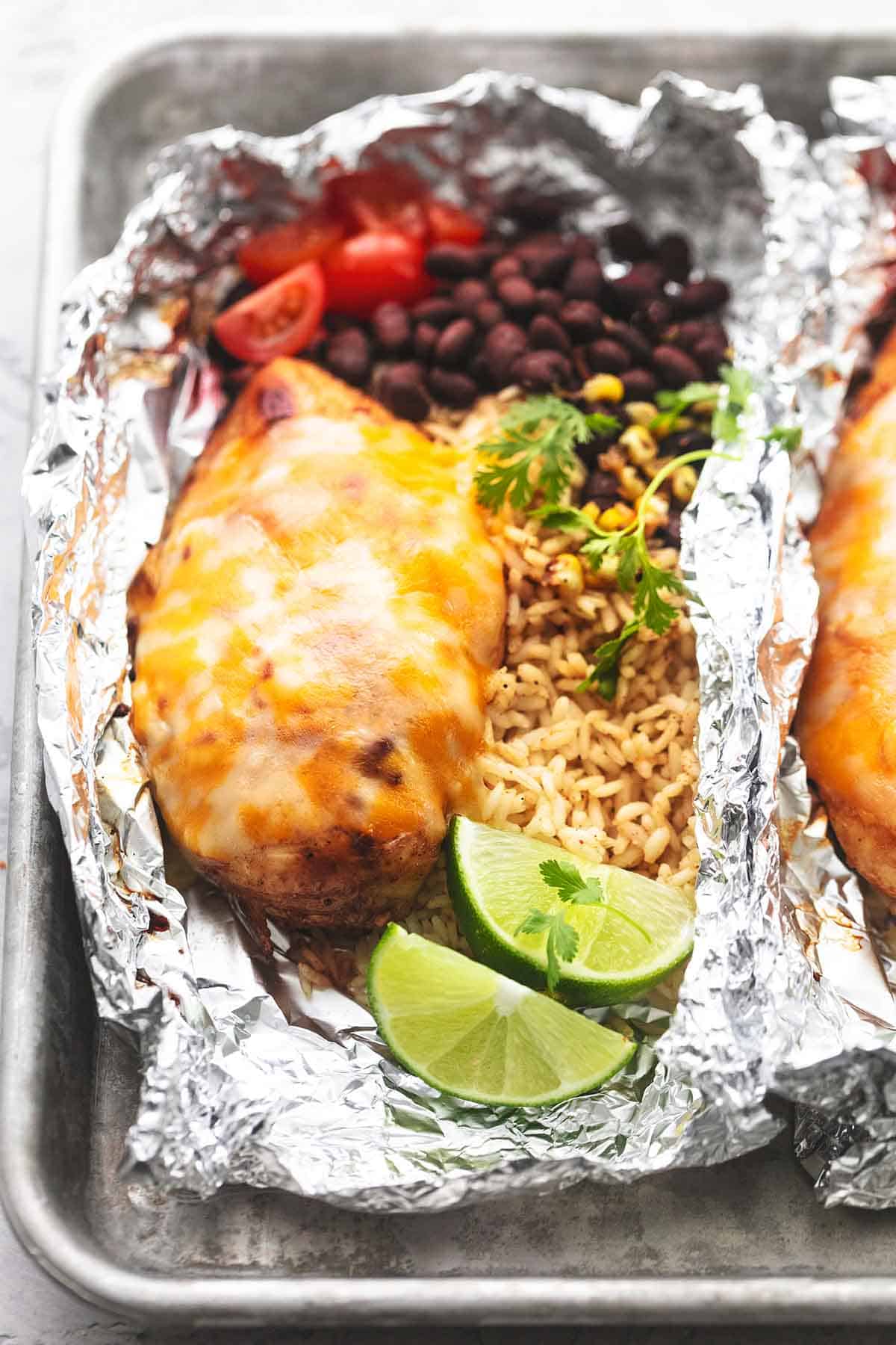 close up of a fiesta lime chicken and rice foil pack on a baking sheet.