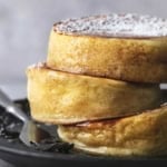 up close stacked japanese souffle pancakes on plate with fork
