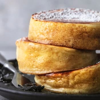 up close stacked japanese souffle pancakes on plate with fork