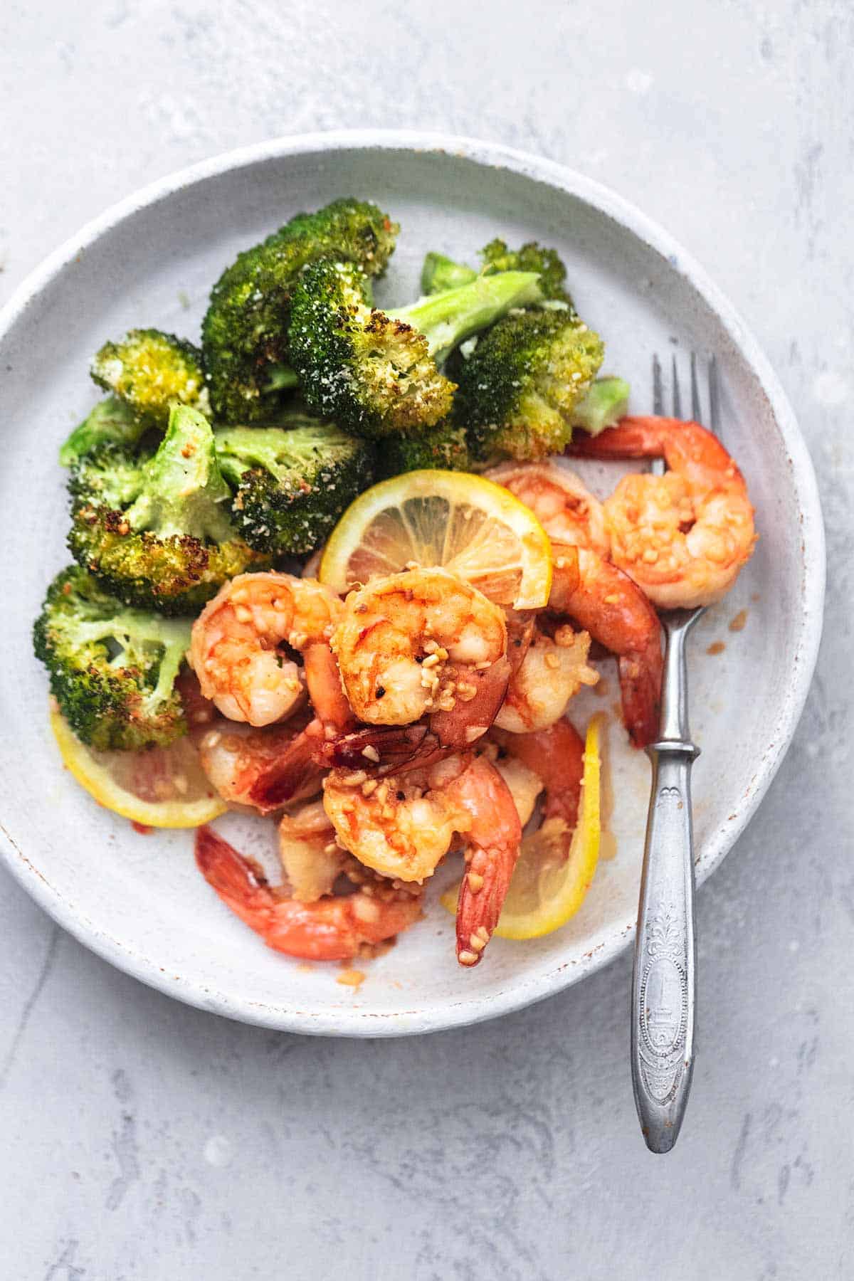 top view of sheet pan shrimp scampi and broccoli with a fork on a plate.