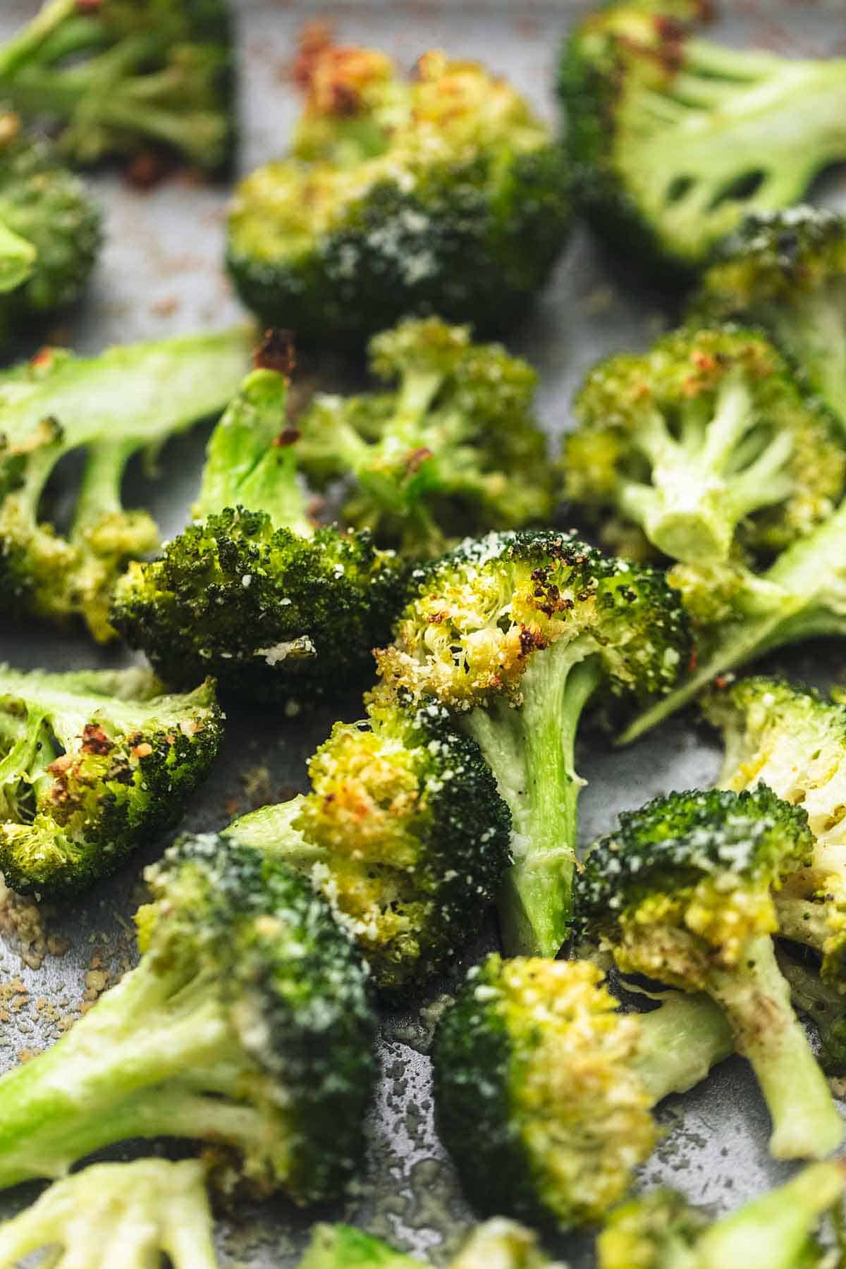 close up of roasted broccoli on a sheet pan.