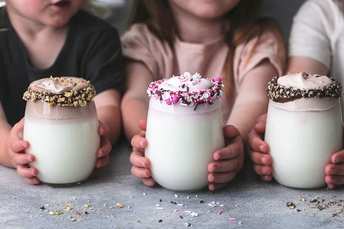 kids holding a glass of whipped milk: three ways each.