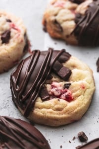 close up view of almond cherry cookie with chocolate chunks, dipped in chocolate