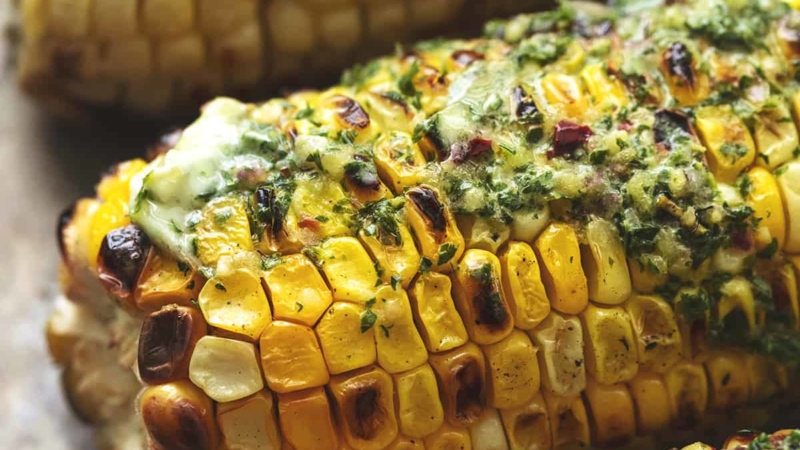 up close grilled corn with herb butter