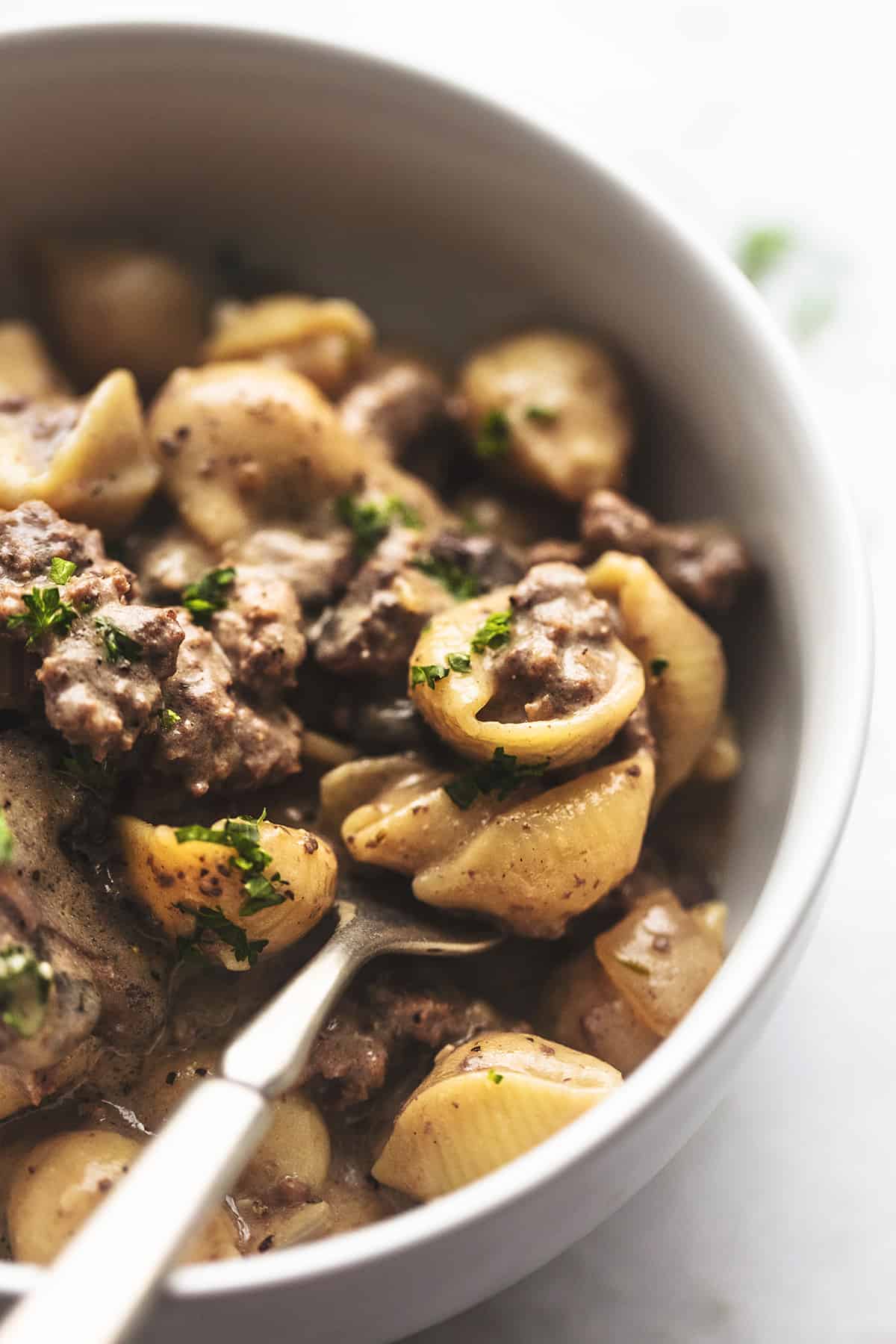 up close view of small cooked pasta shells with beef and brown sauce