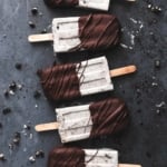 overhead view of popsicles laying on black surface