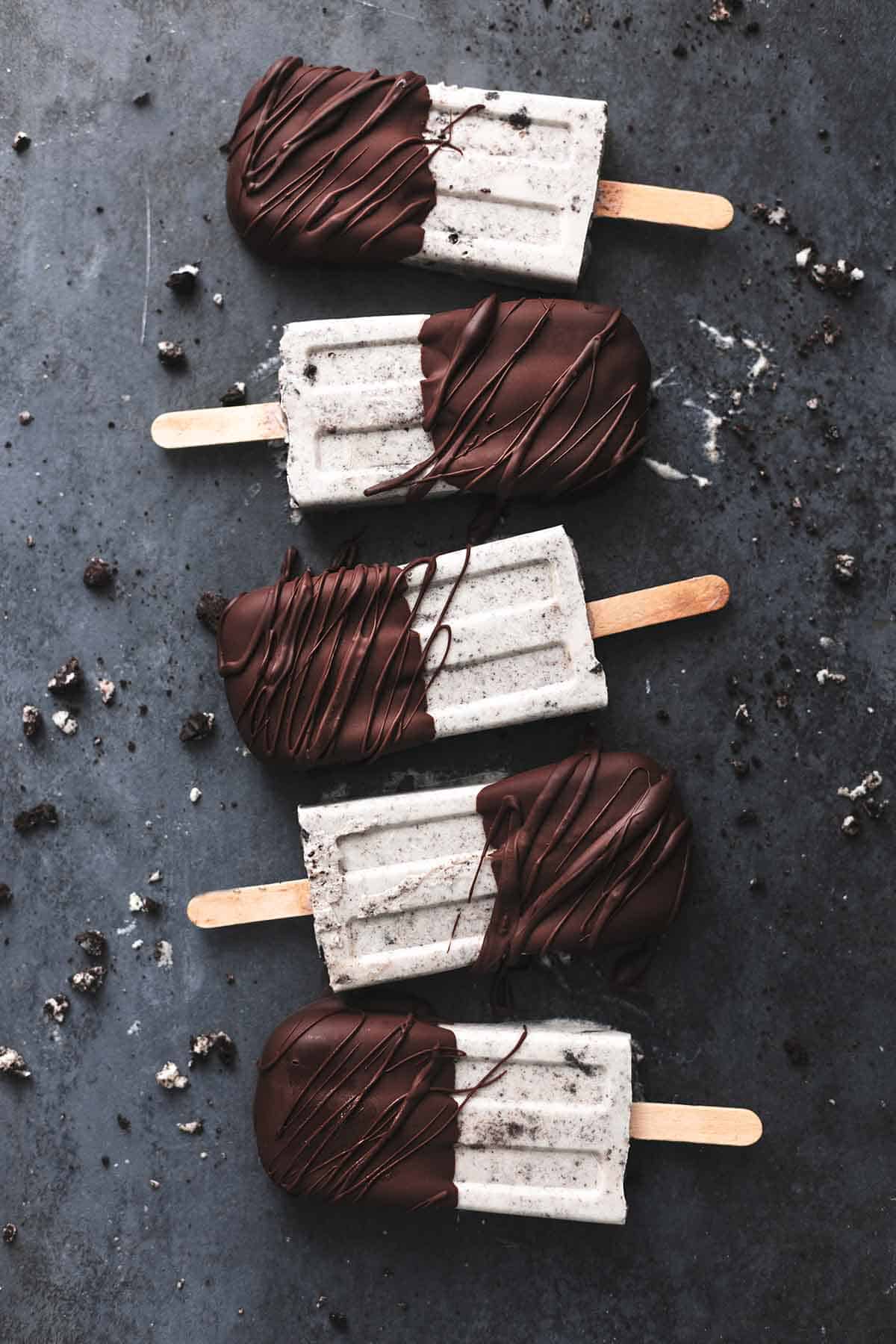 overhead view of popsicles laying on black surface