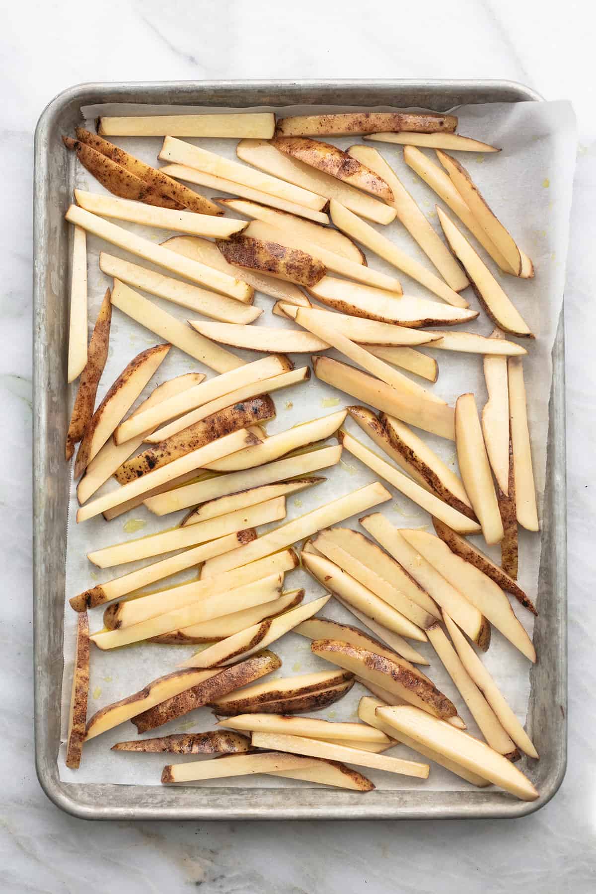top view of unbaked potato strips.