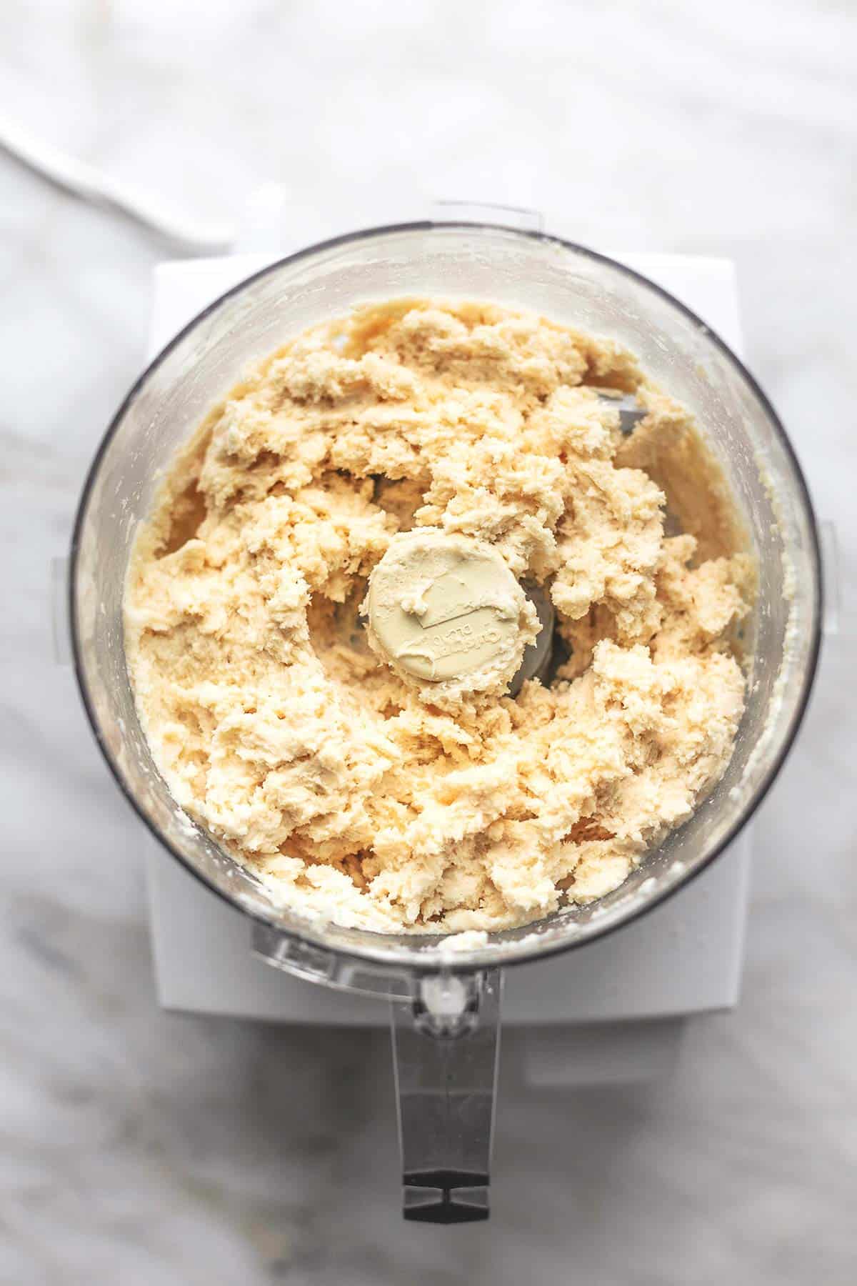 overhead view of soft dough in food processor