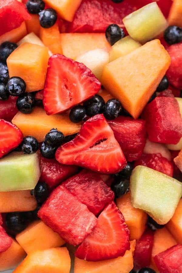 close up view of fruit salad with berries and melon chunks