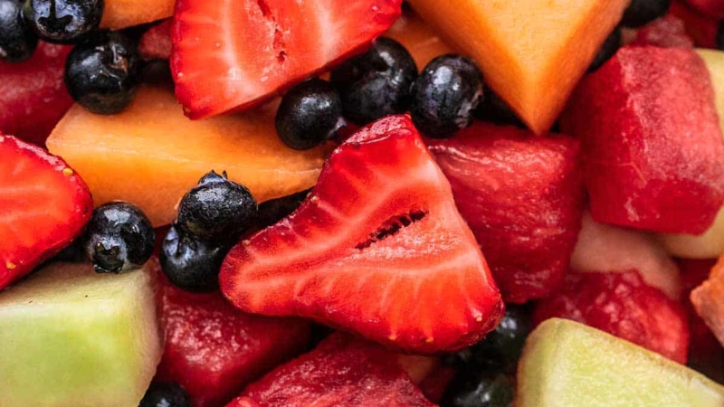 close up view of fruit salad with berries and melon chunks