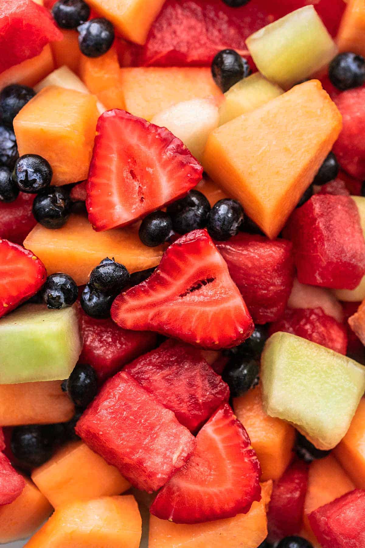 close up view of fruit salad with berries and melon chunks