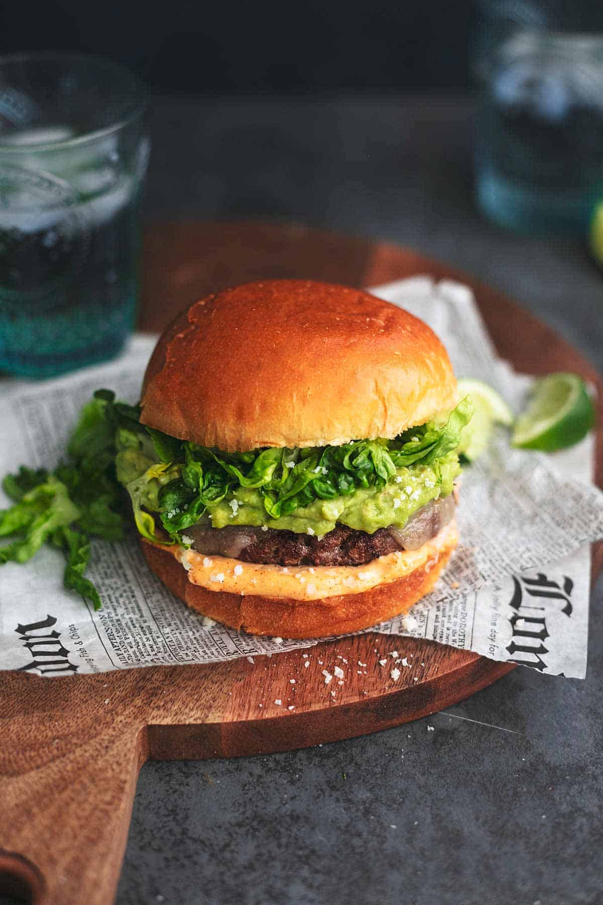 tex-mex turkey burger on a cutting board with newspaper.