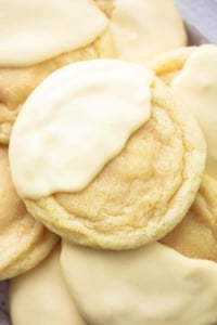 close up view of lemon sugar cookie dipped halfway in white chocolate