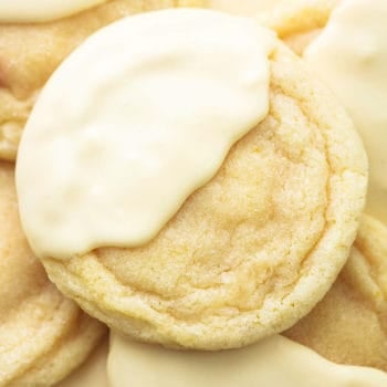 close up view of lemon sugar cookie dipped halfway in white chocolate