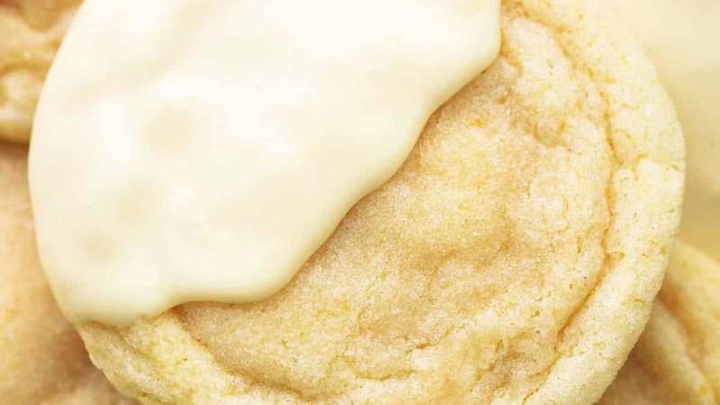 close up view of lemon sugar cookie dipped halfway in white chocolate