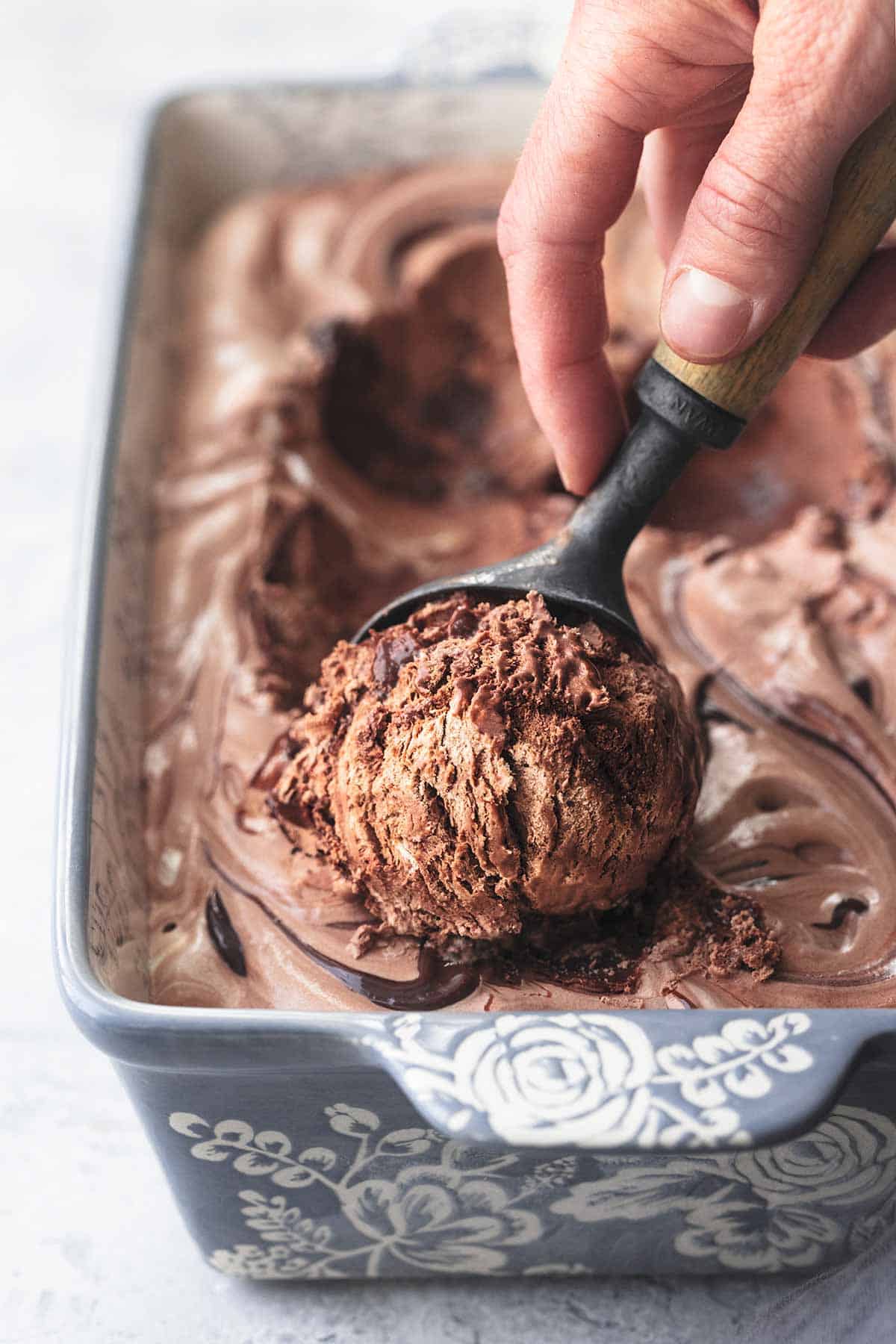 hand scooping chocolate ice cream 