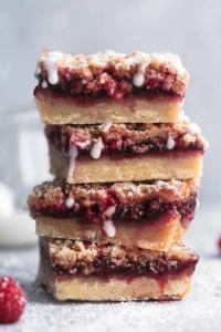 head-on view of stack of raspberry crumb bars with vanilla glaze