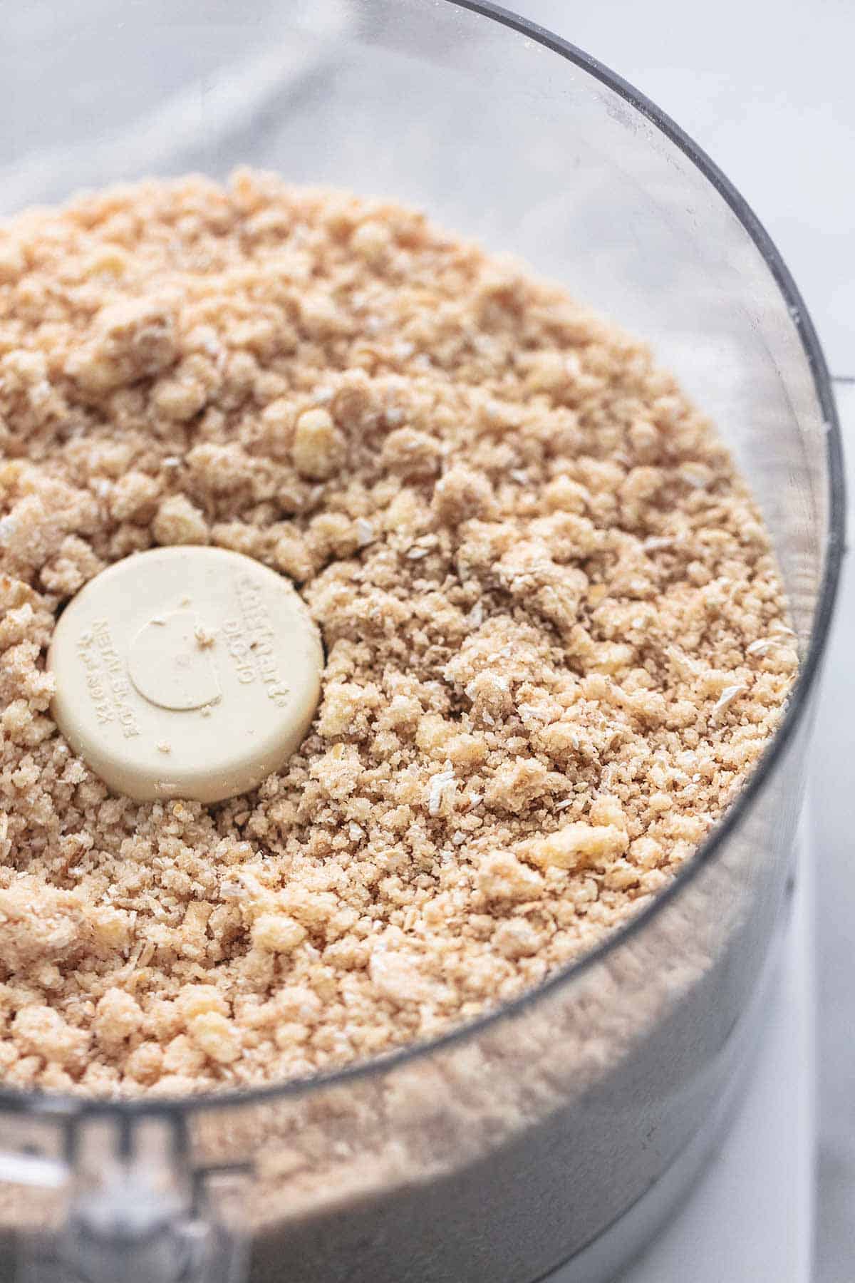 close up of unbaked crumb topping in a food processor.