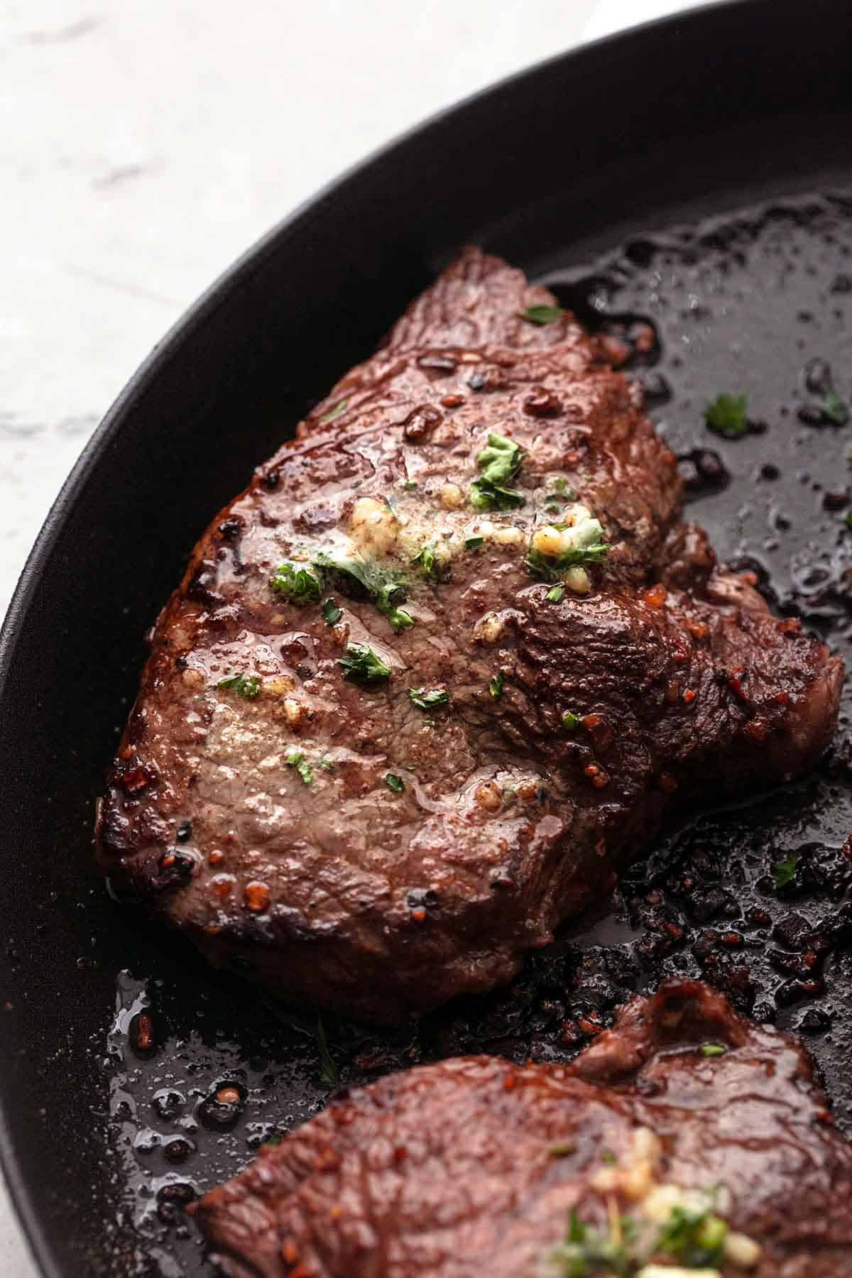 close up of a sirloin steak on a grill pan.