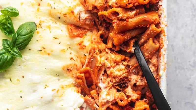 overhead serving spoon dipping into the corner of a pan of pasta