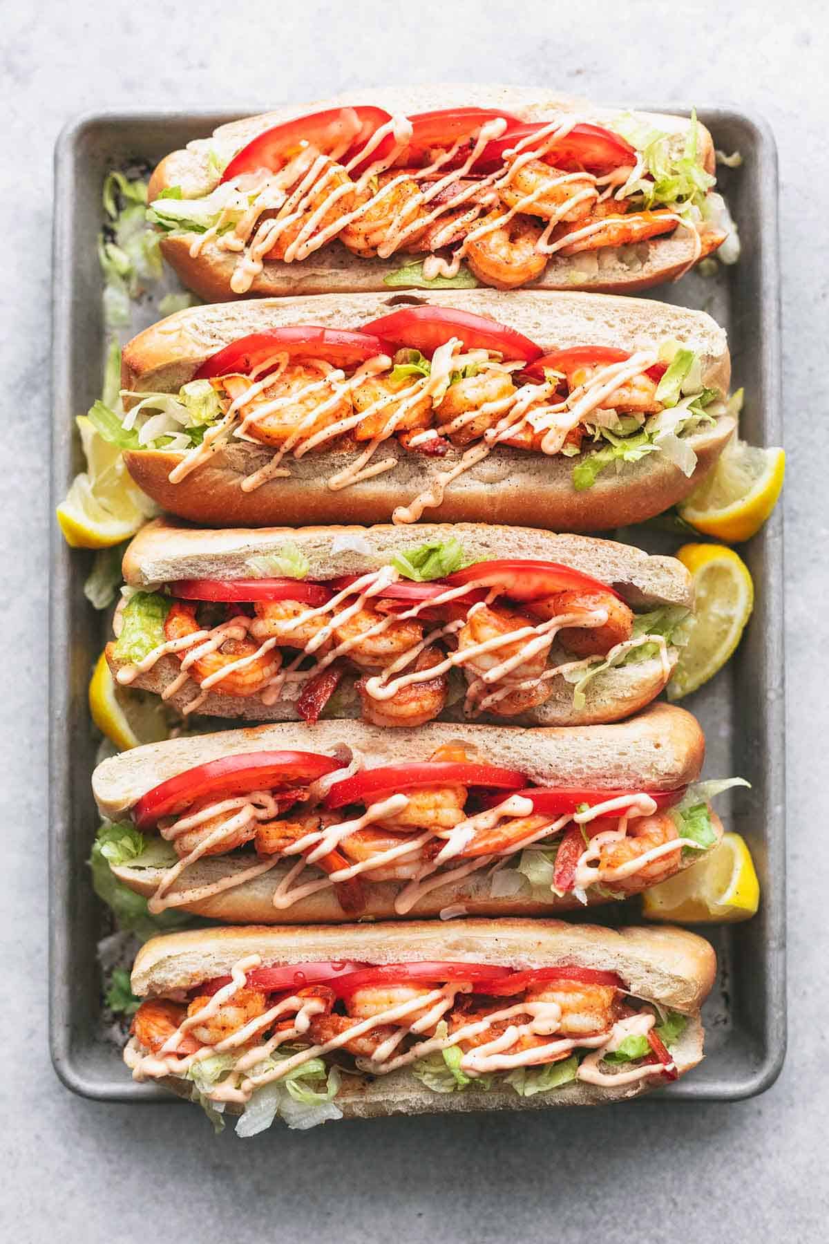 overhead metal pan holding five shrimp po boy sandwiches