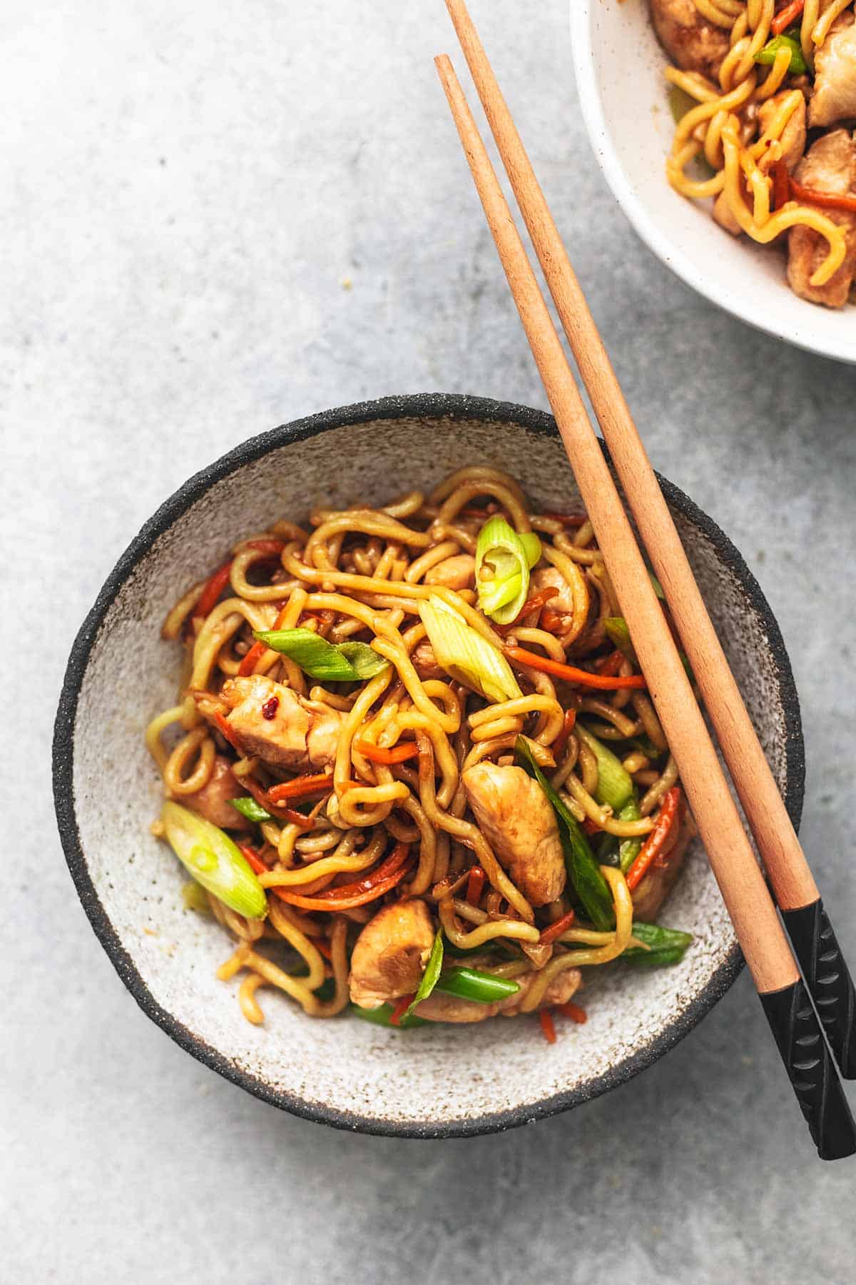 top eww of chicken chow mein in a bowl with chopsticks resting on the side of the bowl.