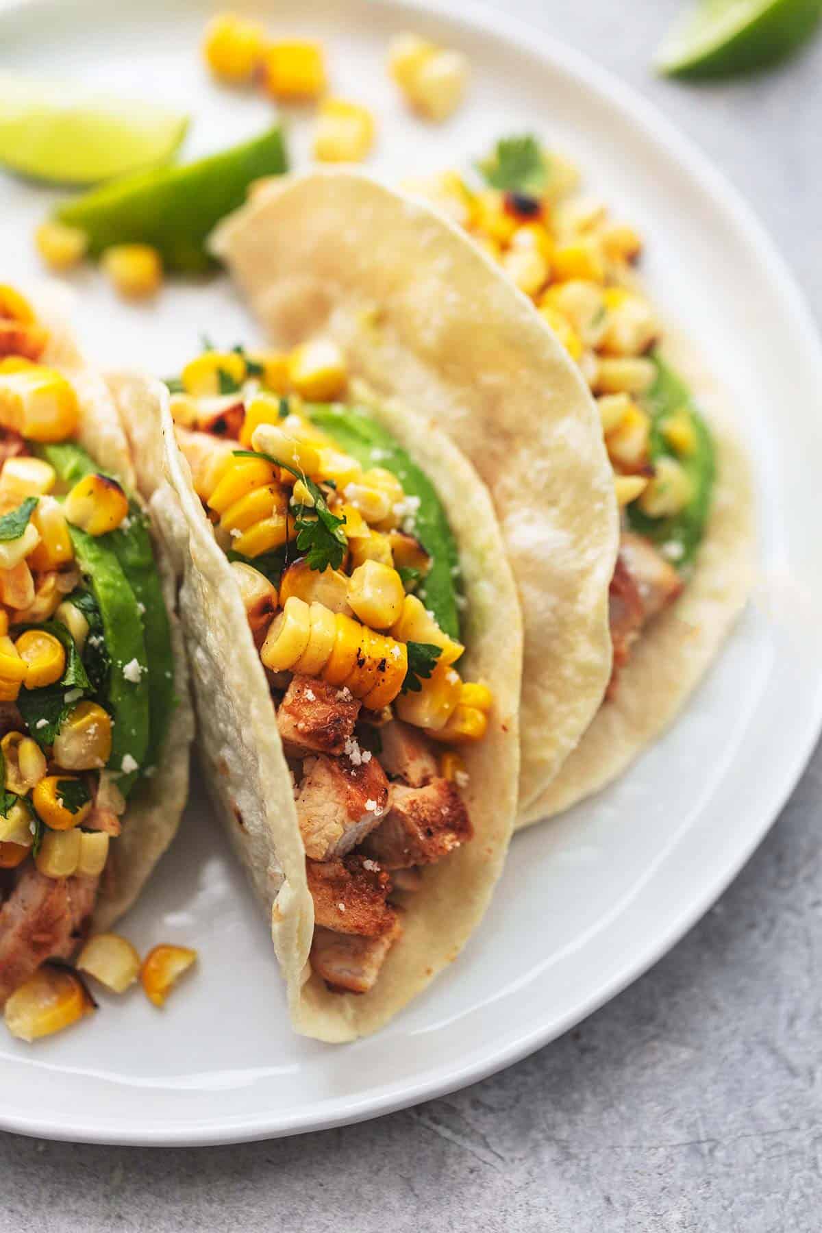 close up of chicken tacos on a plate.