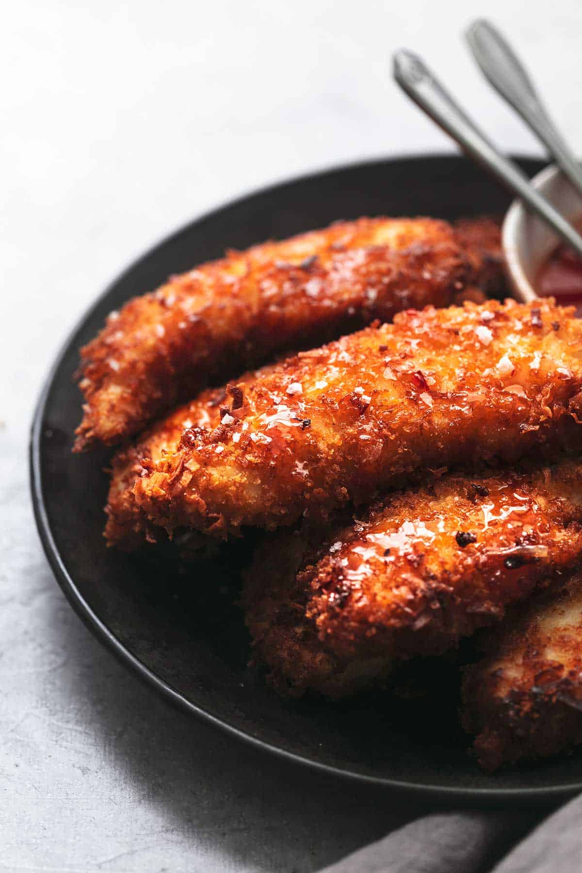 close up of coconut chicken tenders on a plate.