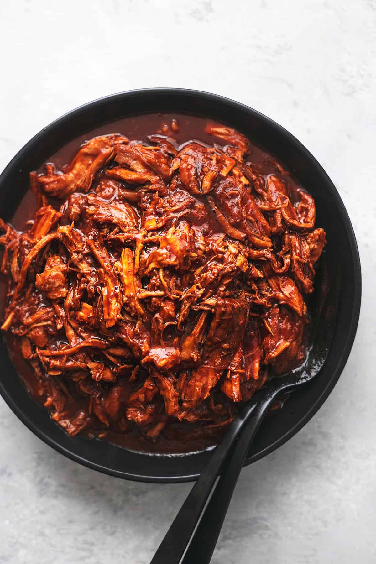 overhead three quarters of a black plate with shredded pork