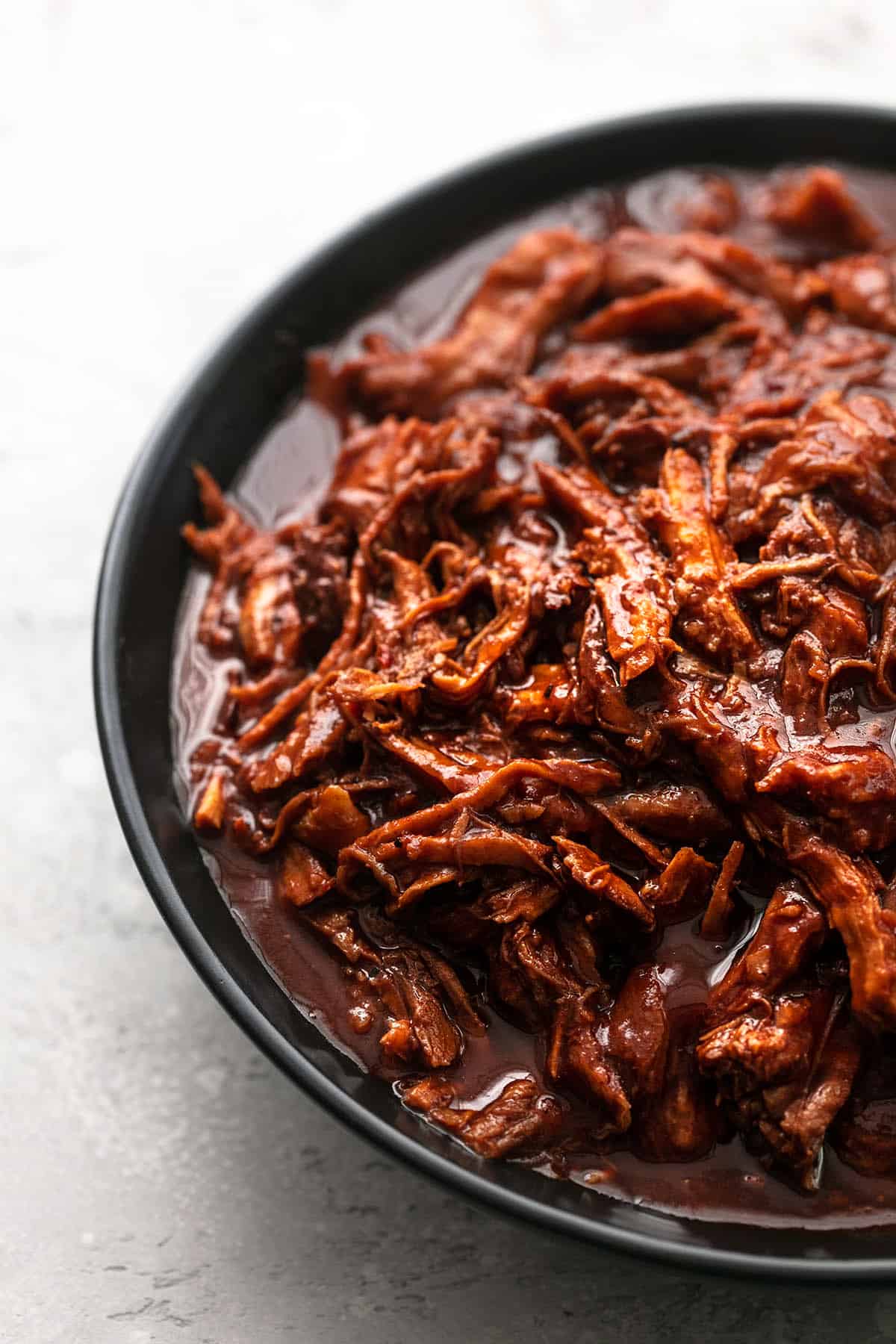 close up of pulled pork on a plate.
