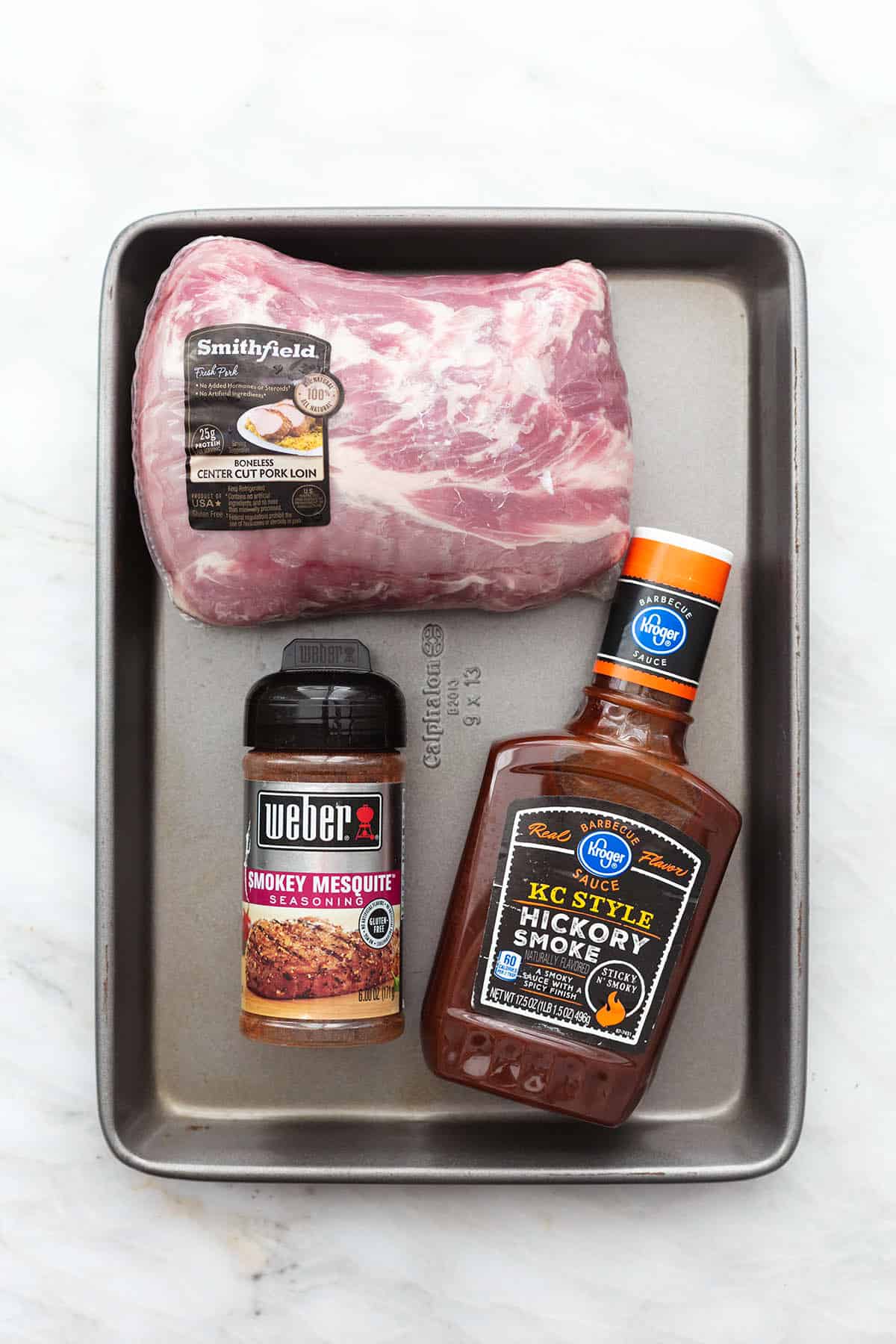 top view of ingredients for pulled pork on a baking sheet.