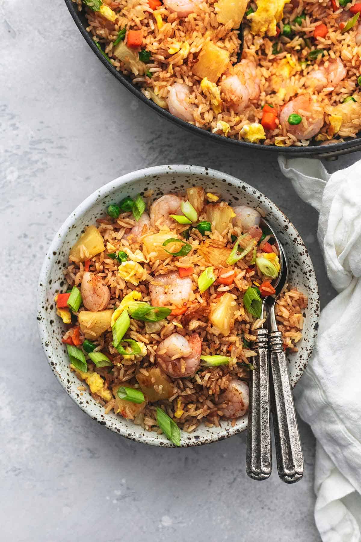 overhead view of bowl and skillet filled with rice